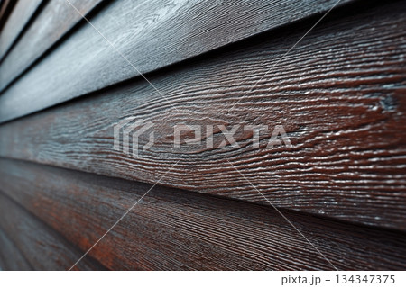 Modern brown wood plank texture. Fiber cement siding. Exterior of composite wall. Plastic material is eco-friendly polymer panels in rows. Wooden grain surface. Hollow WPC boards. Dark oak color. PE. 134347375