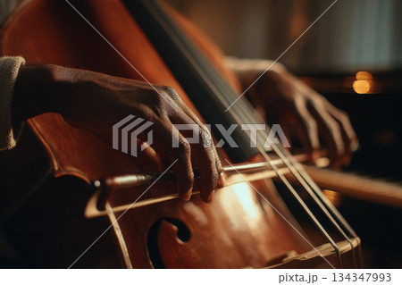 Black musician practicing on instrument in warm setting 134347993