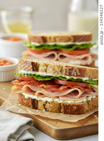 Stacked Deli Meat Sandwich on Whole Grain Bread Stacked Deli Meat Sandwich on Whole Grain Bread 134348227