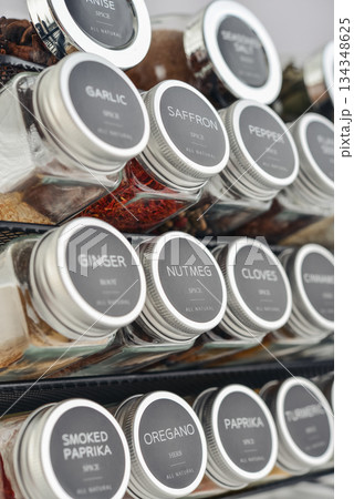 Assorted spices in glass jars with metal lids 134348625