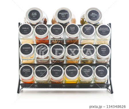 Assorted spices in glass jars with metal lids 134348626