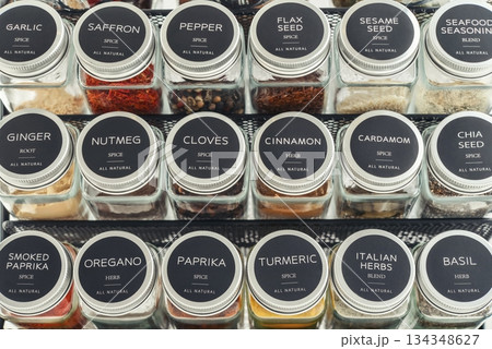 Assorted spices in glass jars with metal lids 134348627