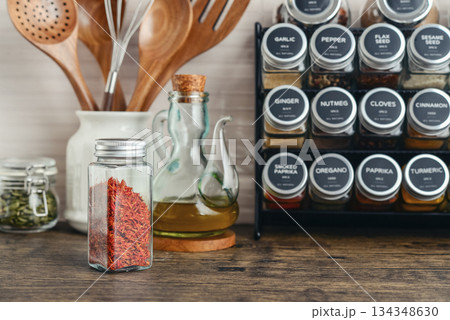 Assorted spices in glass jars with metal lids 134348630