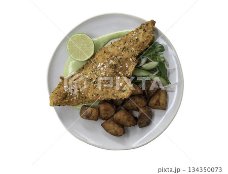 Fish and chips served with Lime, Cucumber, Rocket, Shallots and Green tartar sauce on Ceramic plate isolated on white background with clipping path. 134350073