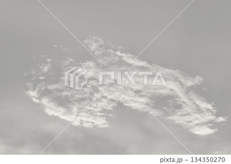 Cloud dancer colored clouds moving across an off-white sky background. Color of the Year Concept 134350270