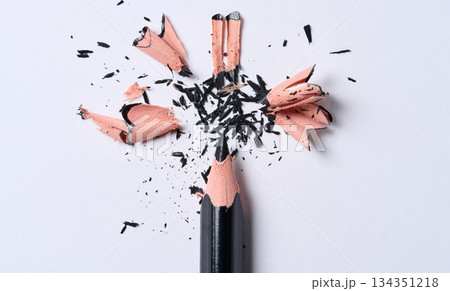 Wooden shavings and black pencil on white background, top view Wooden shavings and black pencil on white background, top view 134351218