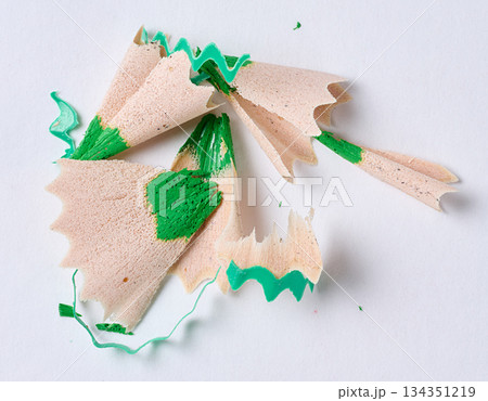 Wooden shavings of green pencil on white background, top view Wooden shavings of green pencil on white background, top view 134351219