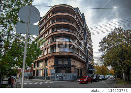 Modern curved building on a city street corner. Curved, modern building on a city street corner with seven stories. 134353788