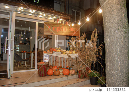 Cozy autumn pumpkin shop display at night. Nighttime scene of a pumpkin shop display. Cozy autumn pumpkin shop display at night. Nighttime scene of a pumpkin shop display. 134353881