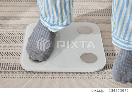 Feet on scale checking health for new year resolution Feet on scale checking health for new year resolution 134353972