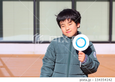 まる札を持つ男の子 134354142