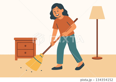 Young woman sweeping floor in apartment 134354152