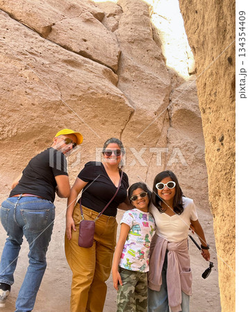 A group of people posing for a photo in a desert 134354409