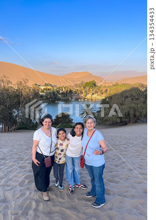 A group of people posing for a picture on a Huacachina Oasis 134354433
