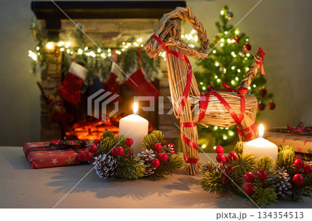 Julbock Christmas goat. A cozy Christmas setting with gifts, candles, a straw goat, 134354513