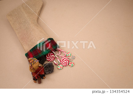 Epiphany Befana's stocking with sweet coal and candy. Italian Epiphany day. Epiphany Befana's stocking with sweet coal and candy. Italian Epiphany day. 134354524