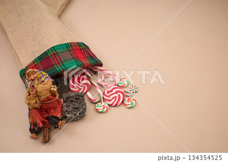 Epiphany Befana's stocking with sweet coal and candy. Italian Epiphany day. Epiphany Befana's stocking with sweet coal and candy. Italian Epiphany day. 134354525