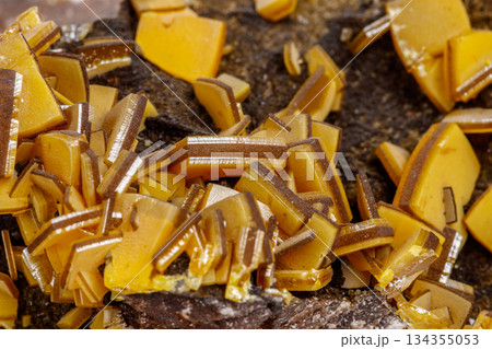 Macro mineral stone yellow Wulfenite on a white background Macro mineral stone yellow Wulfenite on a white background 134355053