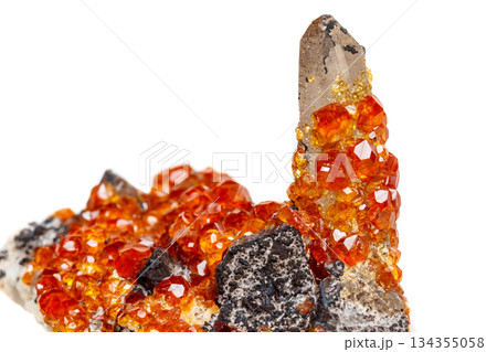 macro mineral stone Spessartine, orange, red garnet with quartz on white background macro mineral stone Spessartine, orange, red garnet with quartz on white background 134355058