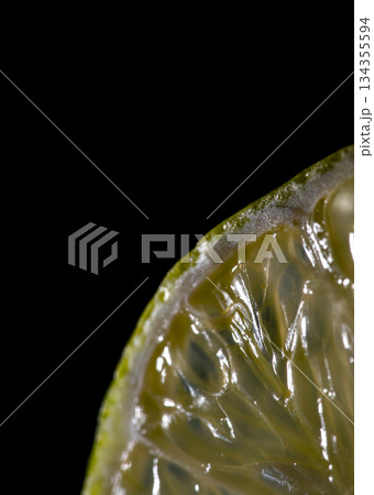 Closeup Of Crisp Lime Slice Showing Textured Rind And Juicy Interior Under Bright Studio Light Closeup Of Crisp Lime Slice Showing Textured Rind And Juicy Interior Under Bright Studio Light 134355594