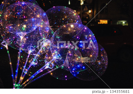 Bunch of bright clear balloons with colorful LED fairy lights glowing in the dark Bunch of bright clear balloons with colorful LED fairy lights glowing in the dark 134355681
