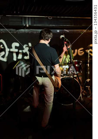 Backstage View Highlighting Lively Rock Concert With Energetic Band Members And Graffiti Walls 134356431