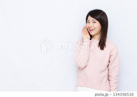 笑顔でささやいている女性 134356510