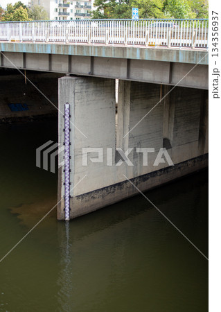 Water level measurement near a concrete bridge shows clear indicator of river 134356937