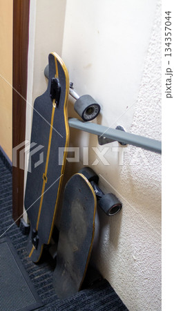 Skateboards resting against a wall in a hallway after a day of riding Skateboards resting against a wall in a hallway after a day of riding 134357044