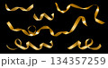 Curly golden ribbon set for gift wrapping on a black background 134357259