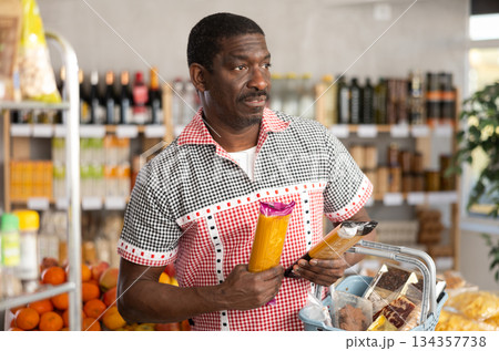 Adult man choosing pasta in store Adult man choosing pasta in store 134357738