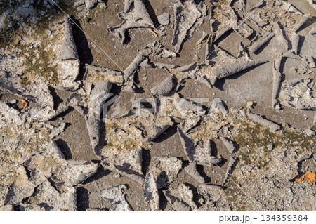 Texture of dry cracked earth ground with peeling gray mud layer and rough surface detail. 134359384
