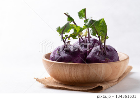 Purple kohlrabi or turnip cabbage in wooden bowl on white background 134361633