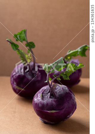 Purple kohlrabi or turnip cabbage on brown background Purple kohlrabi or turnip cabbage on brown background 134361635