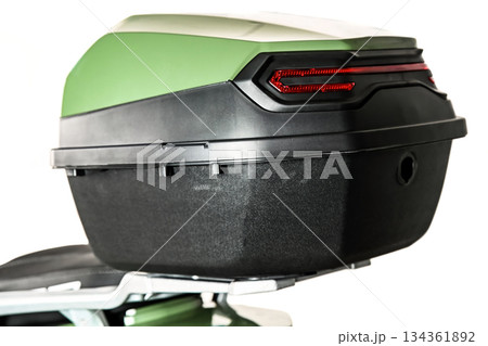 Close up of scooter top case with rear light on white background showing storage box detail and modern motorcycle accessory for transportation use Close up of scooter top case with rear light on white background showing storage box detail and modern motorcycle accessory for transportation use 134361892