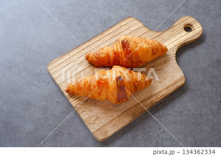 クロワッサン - 焼き立てのクロワッサンがサービングボードにのせられた朝の風景 134362334