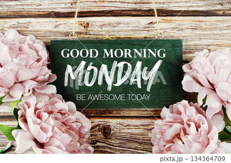 Good Morning Monday Be Awesome Today text written on wooden plank with flower decoration on wooden background 134364709