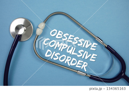Obssessive Compulsive Disorders text with Stethoscope on blue background Obssessive Compulsive Disorders text with Stethoscope on blue background 134365163
