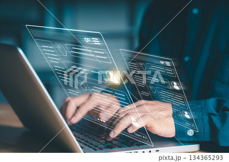 Generative AI chat interface concept. Close-up of hands typing on a laptop with virtual screens displaying user profiles and artificial intelligence conversations, representing future communication. Generative AI chat interface concept. Close-up of hands typing on a laptop with virtual screens displaying user profiles and artificial intelligence conversations, representing future communication. 134365293