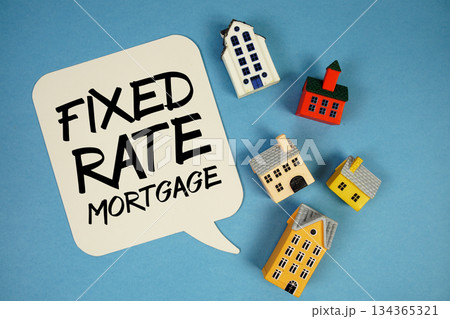 Fixed-Rate Mortgage text with house models on blue background Fixed-Rate Mortgage text with house models on blue background 134365321