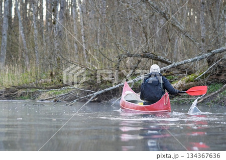 Paddling Through Serene Waters Person Kayaking on a Peaceful River in Nature s Embrace 134367636