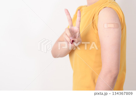 Adult Woman with bandage after received vaccine. Vaccination and Immunization for Influenza, HPV, Zoster, IPD, DTP or Diphtheria, Tetanus and Pertussis, MMR, Hepatitis B, Covid and Varicella vaccine 134367809