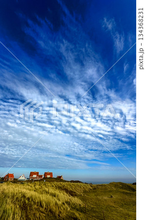 A Beautiful Scenic Coastal Landscape Featuring Dramatic Clouds, Rolling Dunes, and Serenity A Beautiful Scenic Coastal Landscape Featuring Dramatic Clouds, Rolling Dunes, and Serenity 134368231