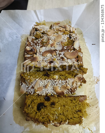 Pumpkin bread loaf sliced nuts seeds rustic homemade golden moist with cozy aroma and crunchy topping 134368675