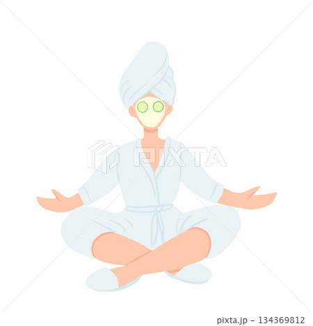 Woman in bathrobe, towel and face mask meditating in lotus pose. Home spa relaxing with cucmber slices on eyes. Woman in bathrobe, towel and face mask meditating in lotus pose. Home spa relaxing with cucmber slices on eyes. 134369812