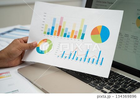 Asian business woman working with financial graph. Asian business woman working with financial graph. 134369896