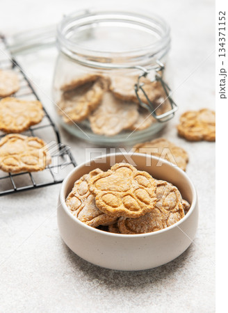 Homemade dog treats in paw print shape cooling and stored 134371152