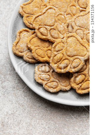 Homemade paw print dog treats on a plate Homemade paw print dog treats on a plate 134371156