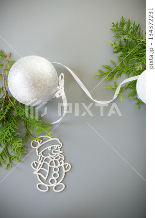 Winter card with a fir branch and a New Year's decoration 134372231