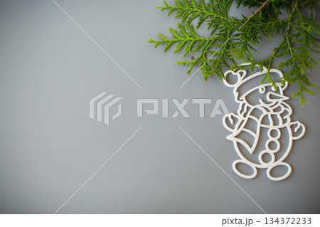 New Year's white ball and snowman on a background with a fir branch 134372233